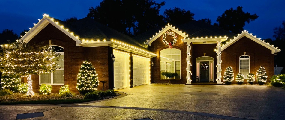 White holiday lights strung up by professionals around perimeter of a home in Jeffersontown, KY.